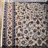 R03. Ivory colored Oriental rug. 